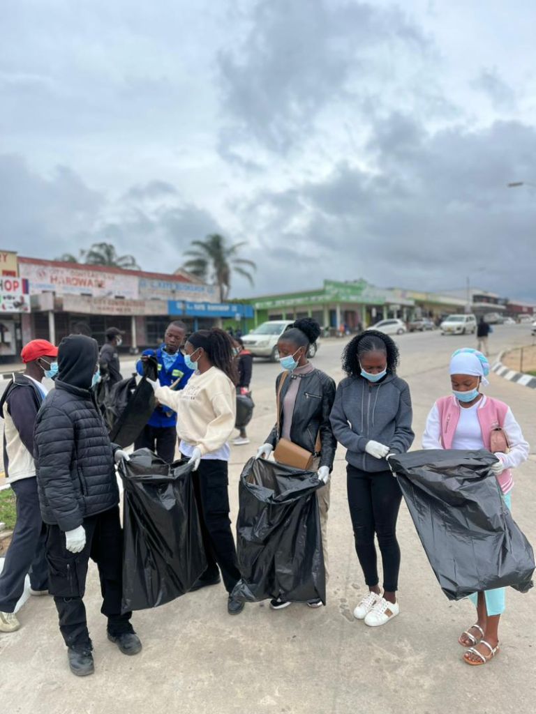 YES Zimbabwe volunteers holding waste collection bags during a community clean-up campaign